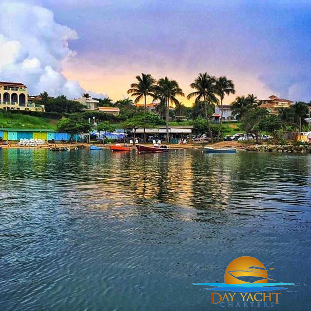 Private yacht with guests relaxing on the sundeck, luxury boat rental Puerto Rico